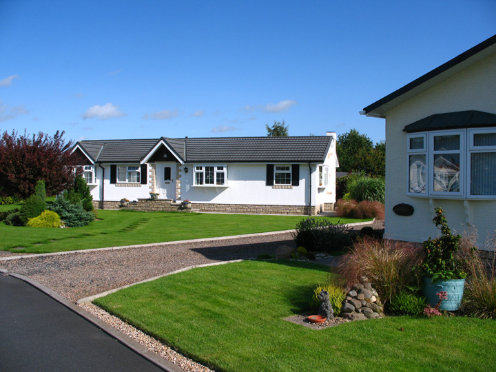 Exterior view of two homes with front garden